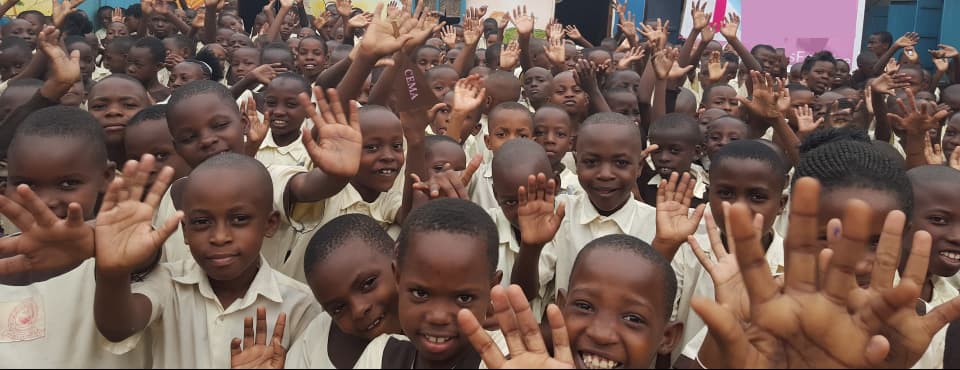 Chidren gathered outside of a classroom after CEMA Ministry event.